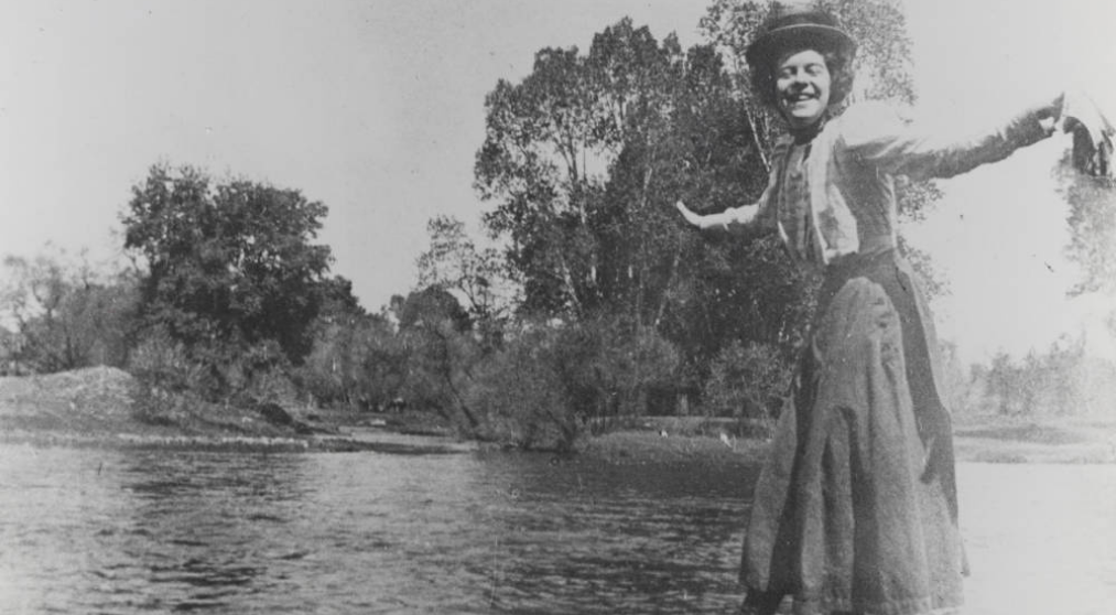 vintage-photo-woman-playing-in-front-of-cache-le-poudre-river