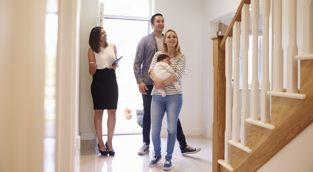 couple-with-baby-tour-a-home-with-realtor