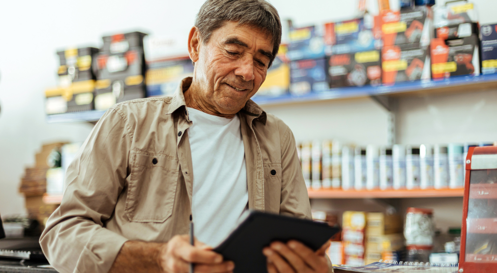 Business owner in his store reviewing business HELOC benefits 